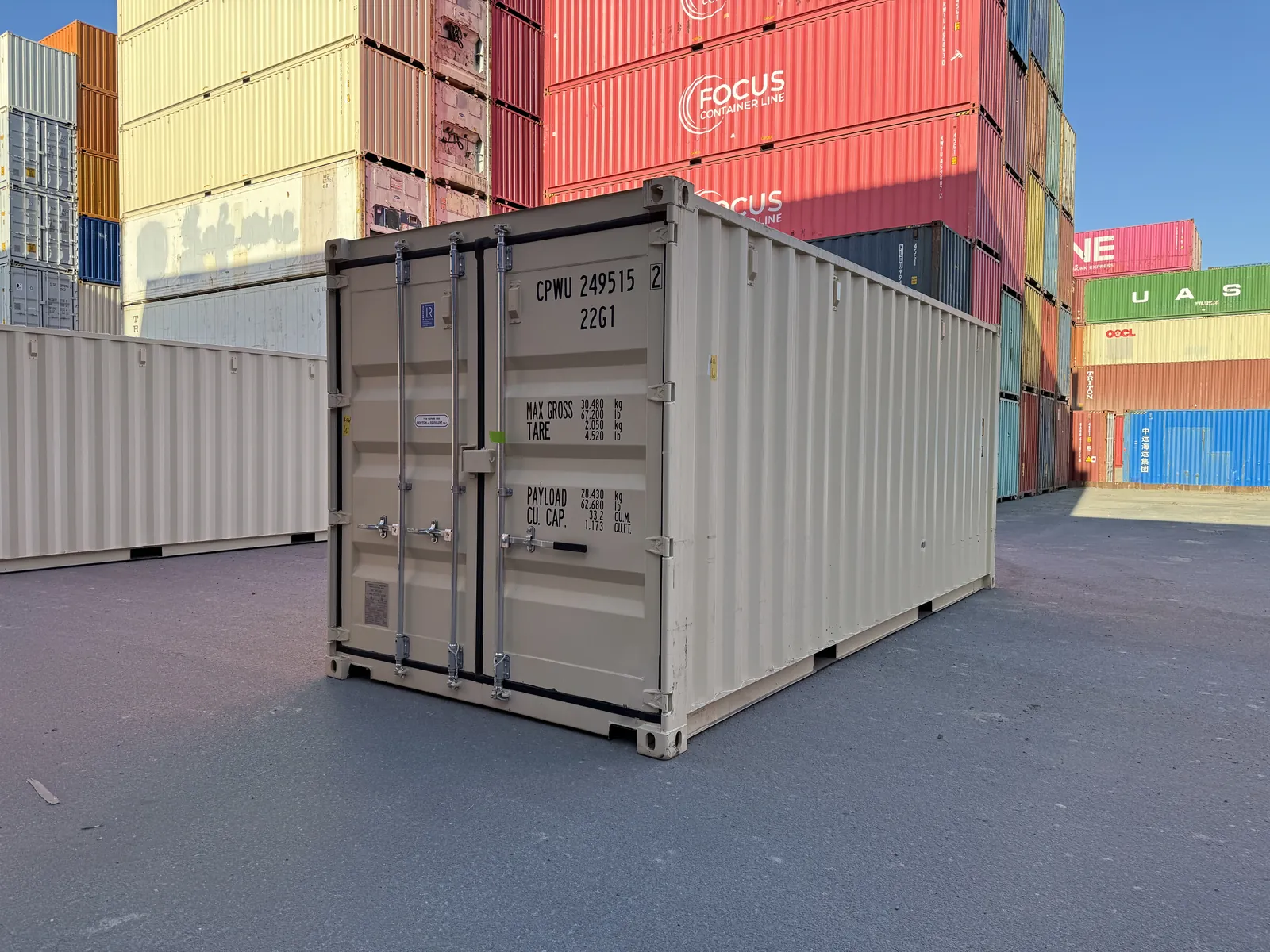 Cream 20ft shipping container in clean condition, doors closed